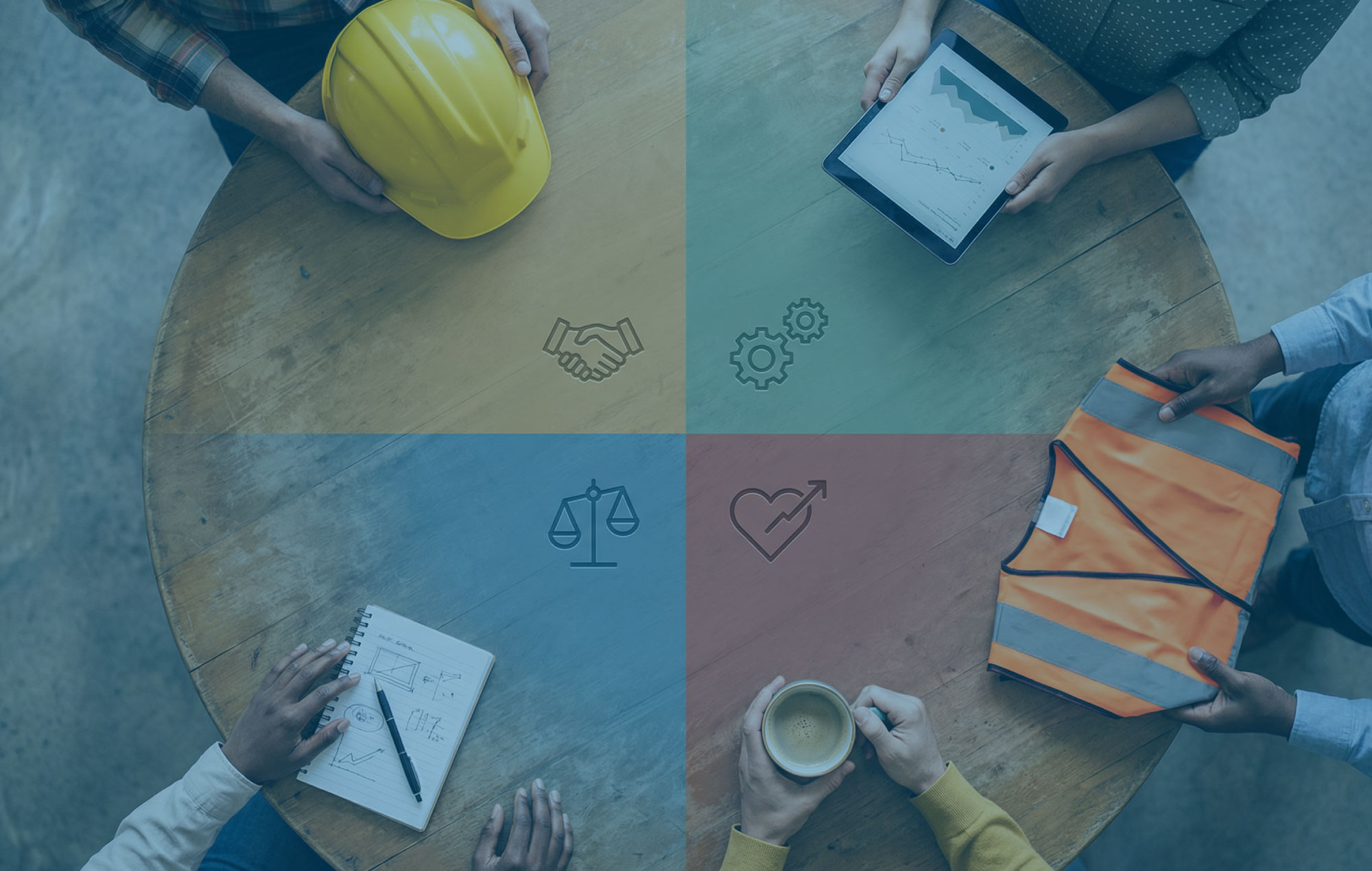Top down view of a round table divided into coloured value segments with diverse hands reaching in with notebooks and tools